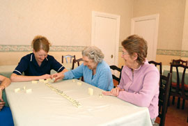 Ashcroft house staff and residents enjoying a game of dominoes